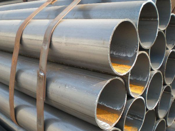 Welded steel pipes stacked for industrial supply